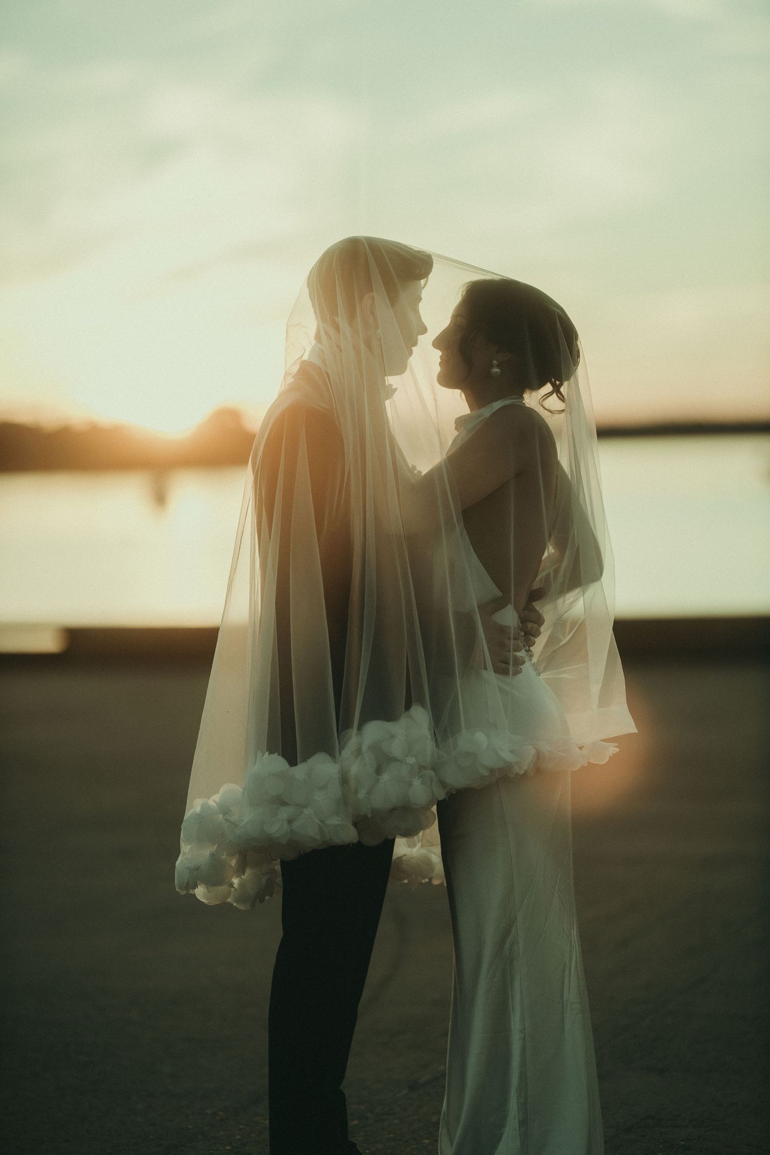 Ethereal sunset wedding portraits with soft dreamy lighting effects.