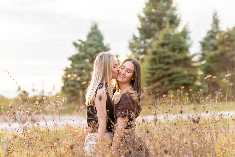 Natural outdoor portrait session in field with evergreen trees in background at  AT KOMOKA PROVINCIAL PARK Pond.