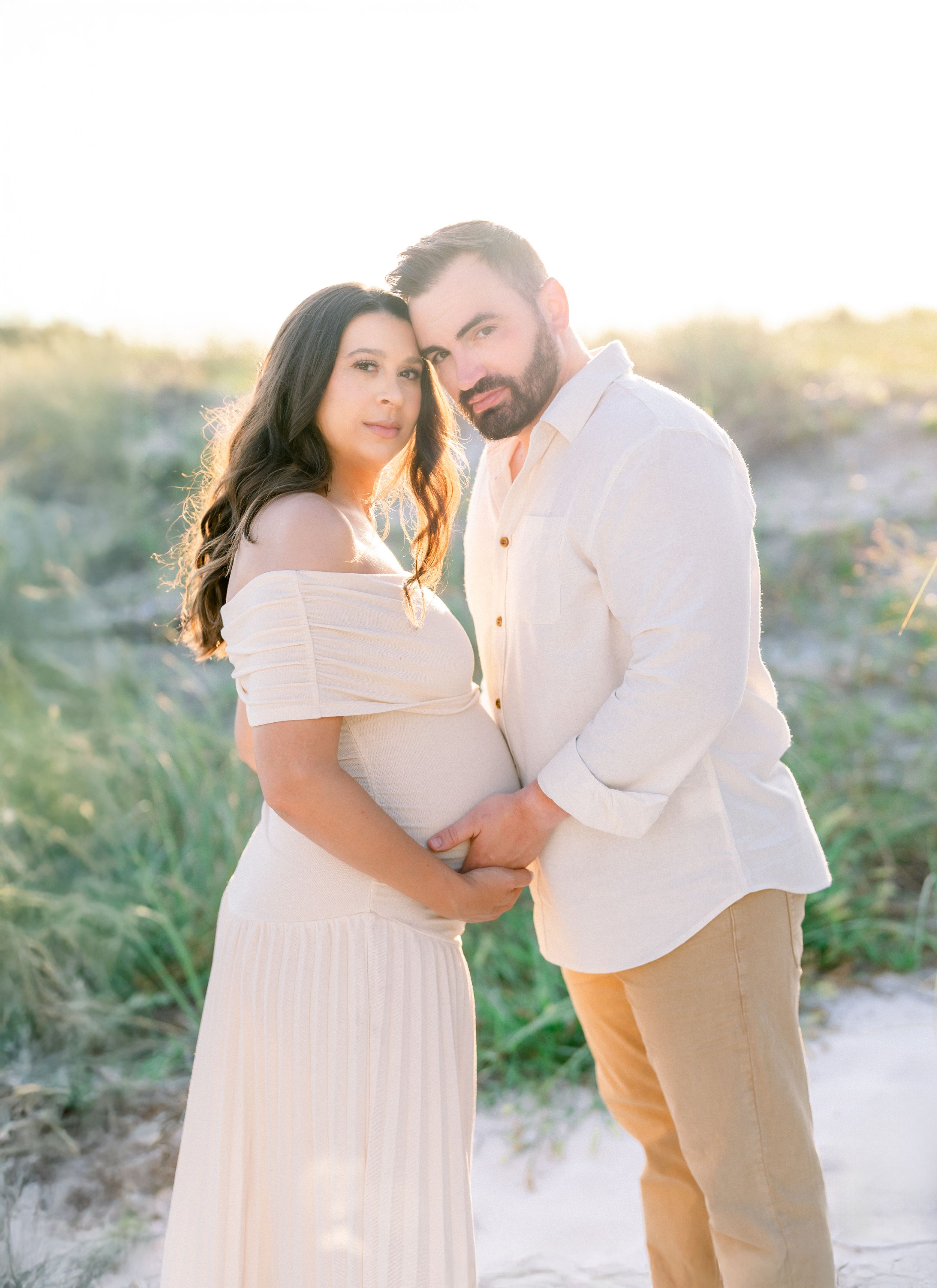 Mom and Dad during their pregnancy session on their baby moon at The Don Cesar on St. Pete Beach at golden hour photography