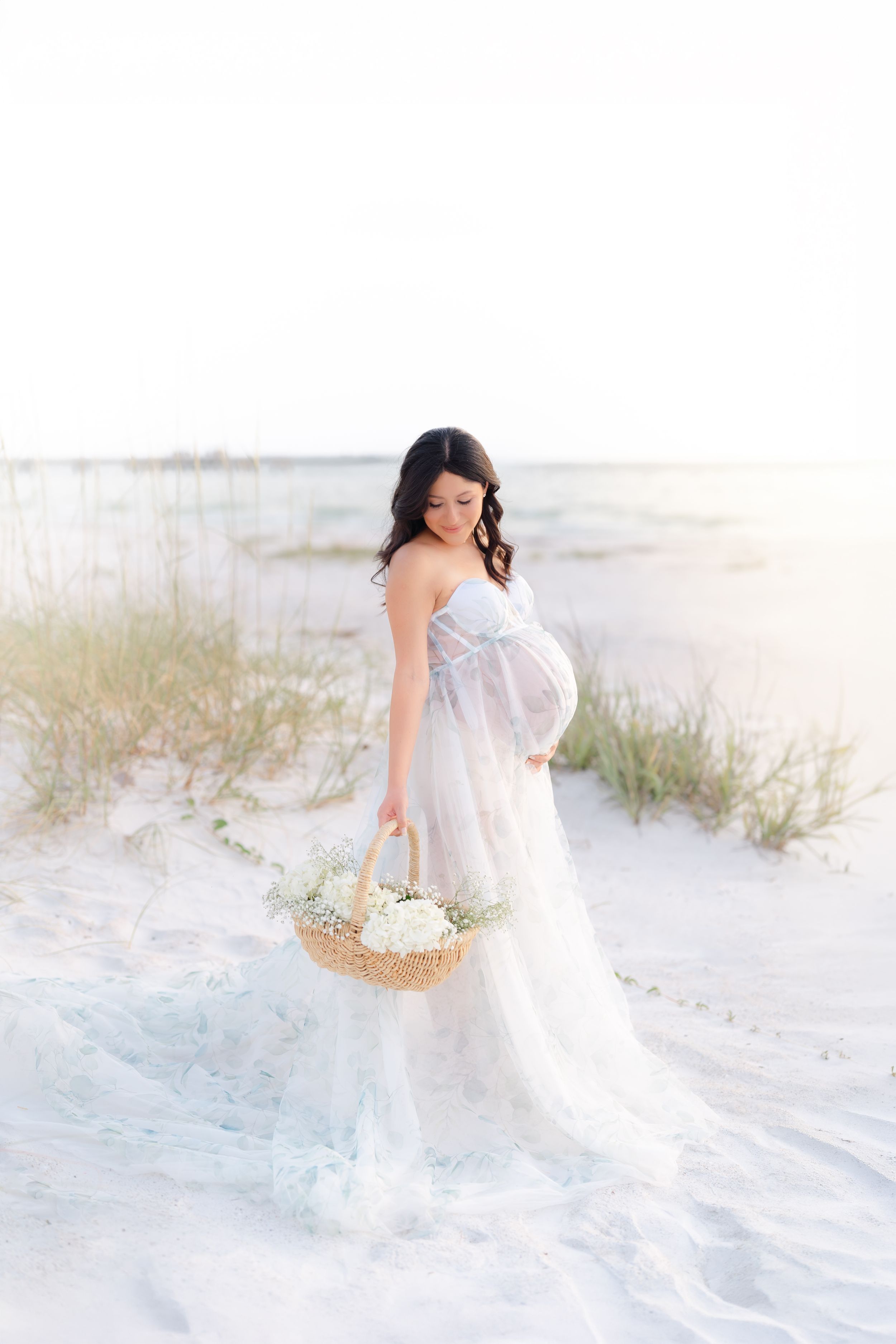 maternity session on the beach in St. Pete at golden hour, beautiful mom holding her belly in Florida