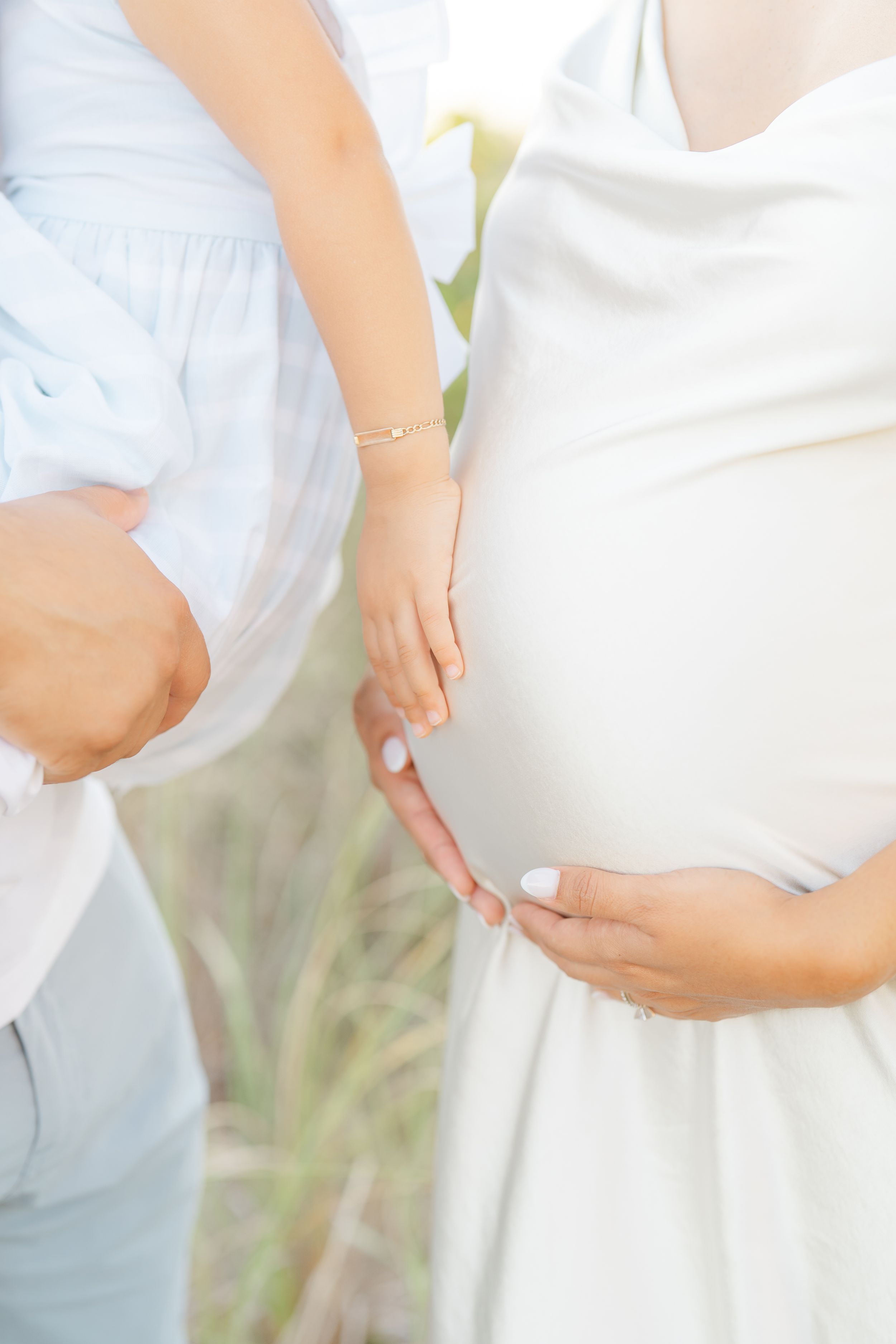 pregnancy photoshoot daughter touching mom's belly emotional Tampa florida photographer