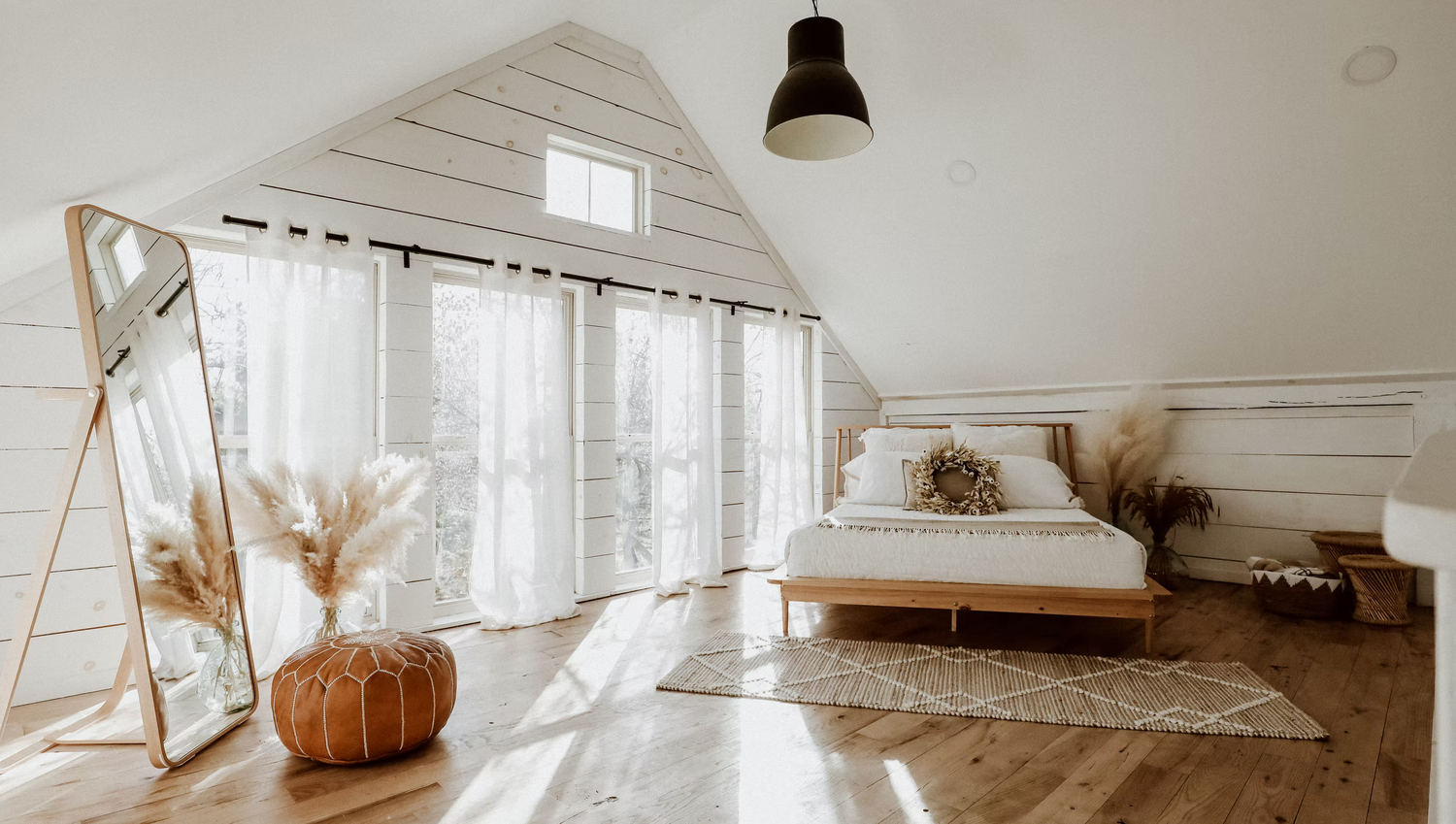 Clean, bright bedroom setting with white decor and natural light.