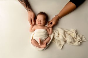 NH Newborn Photographer New Hampshire Newborn Photographer NH Photographer newborn holding parents hands in studio
