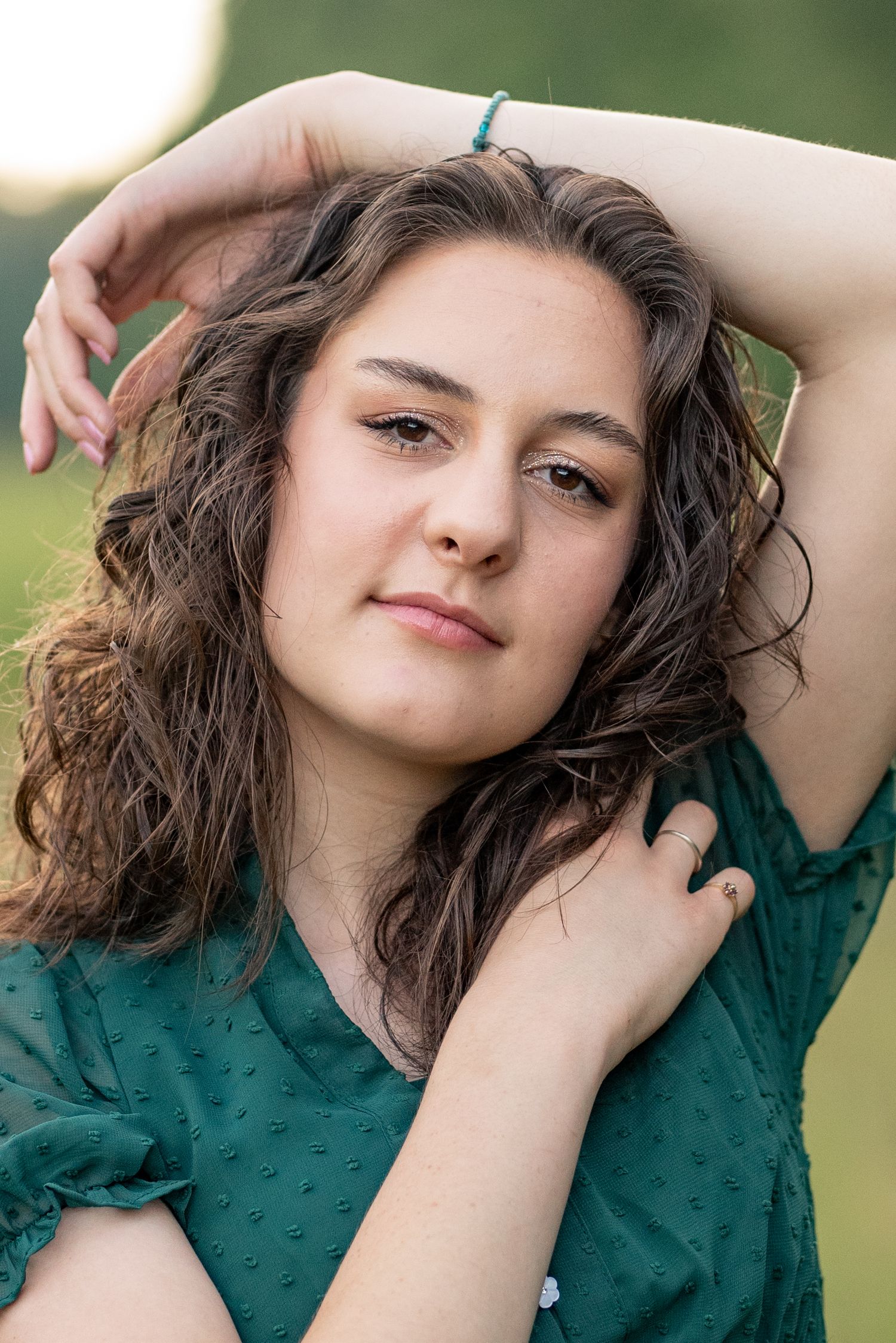 Portrait featuring emerald green clothing against a soft natural background.