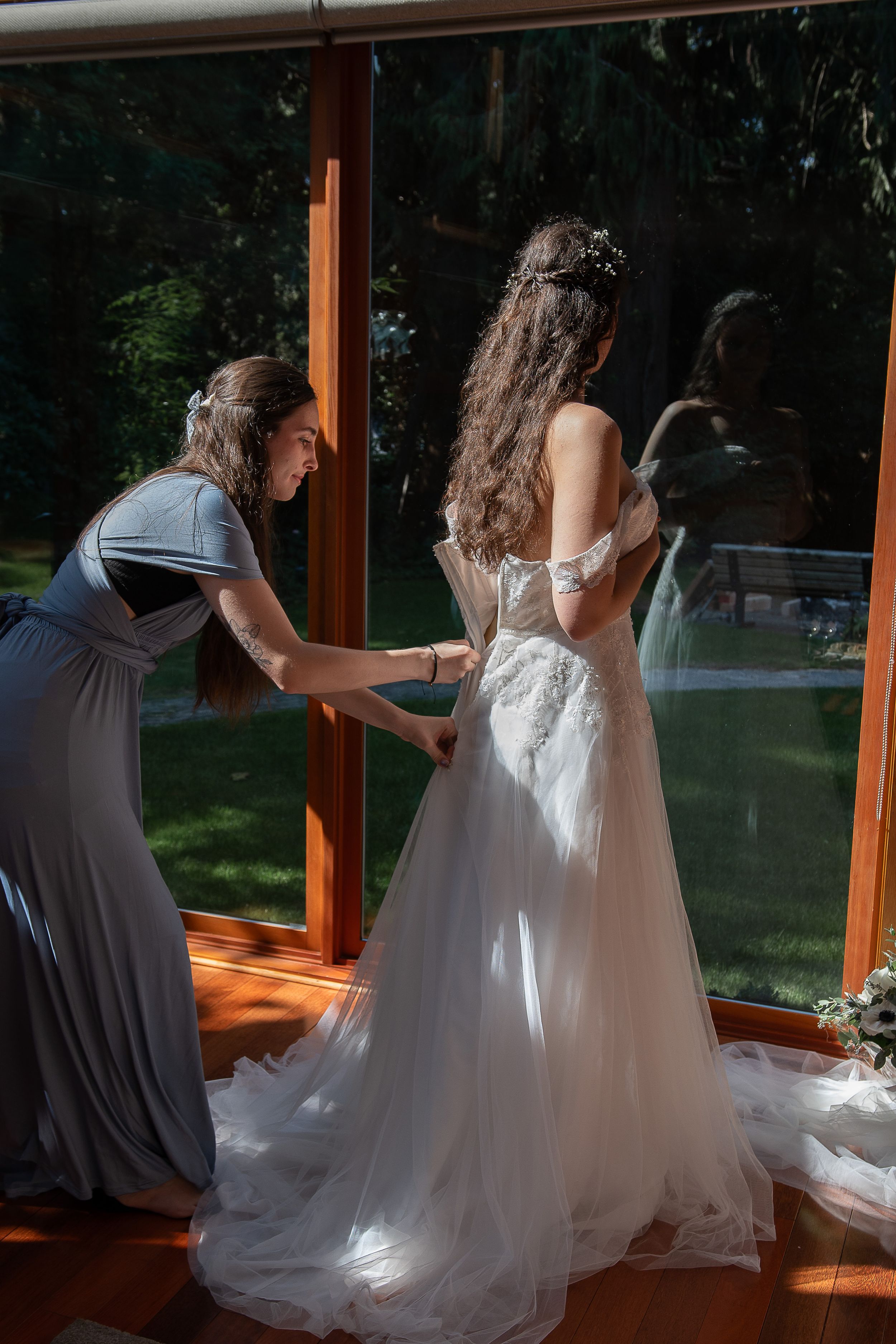 Two people in wedding attire dance together in front of sunlit windows in a romantic sequence of photos.