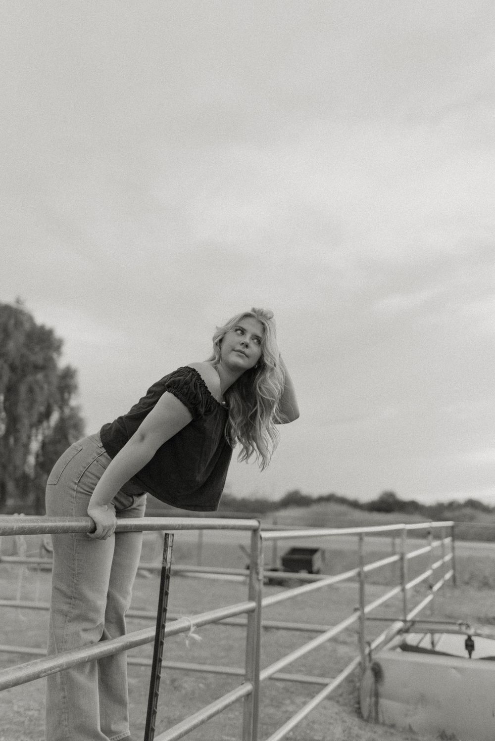 Photo of a high school senior at her senior photos in Gilbert, Arizona at a stunning pasture location.