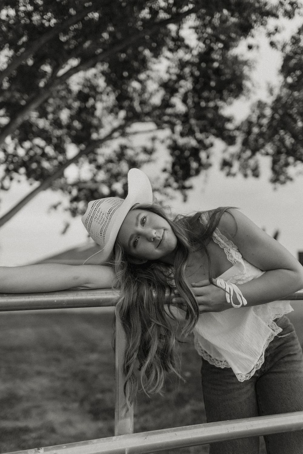Photo of a high school senior at her senior photos in Gilbert, Arizona in a pasture setting.