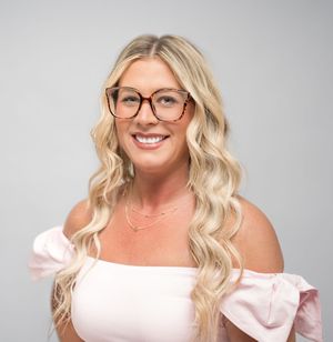 Studio portraits in pink off-shoulder dress against light grey background.