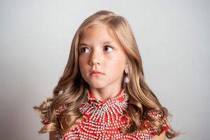 A series of portraits showing a model wearing a red and white checkered scarf in different poses against a light background.