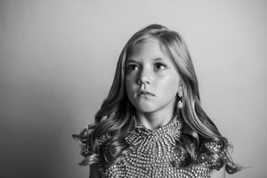 A series of black and white portrait photos showing different expressions and poses.