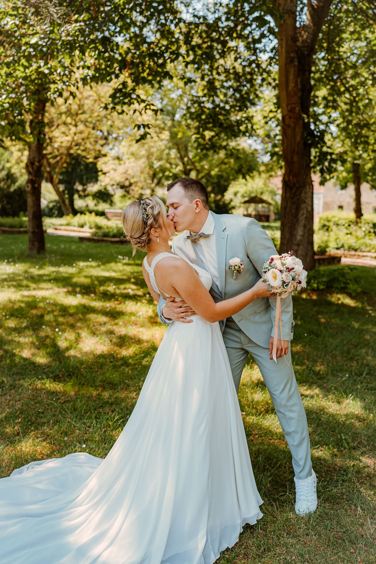 Intimate romantic couple sharing tender kisses in moody lighting with warm orange glow.