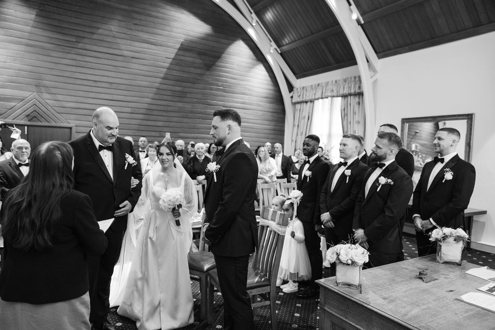 A series of black and white wedding ceremony photographs showing emotional moments and interactions during the service.