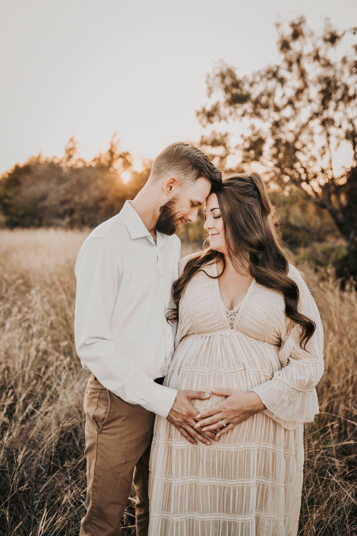 a quiet moment of romance between a new dad and his beautiful wife who is about to have their third little boy