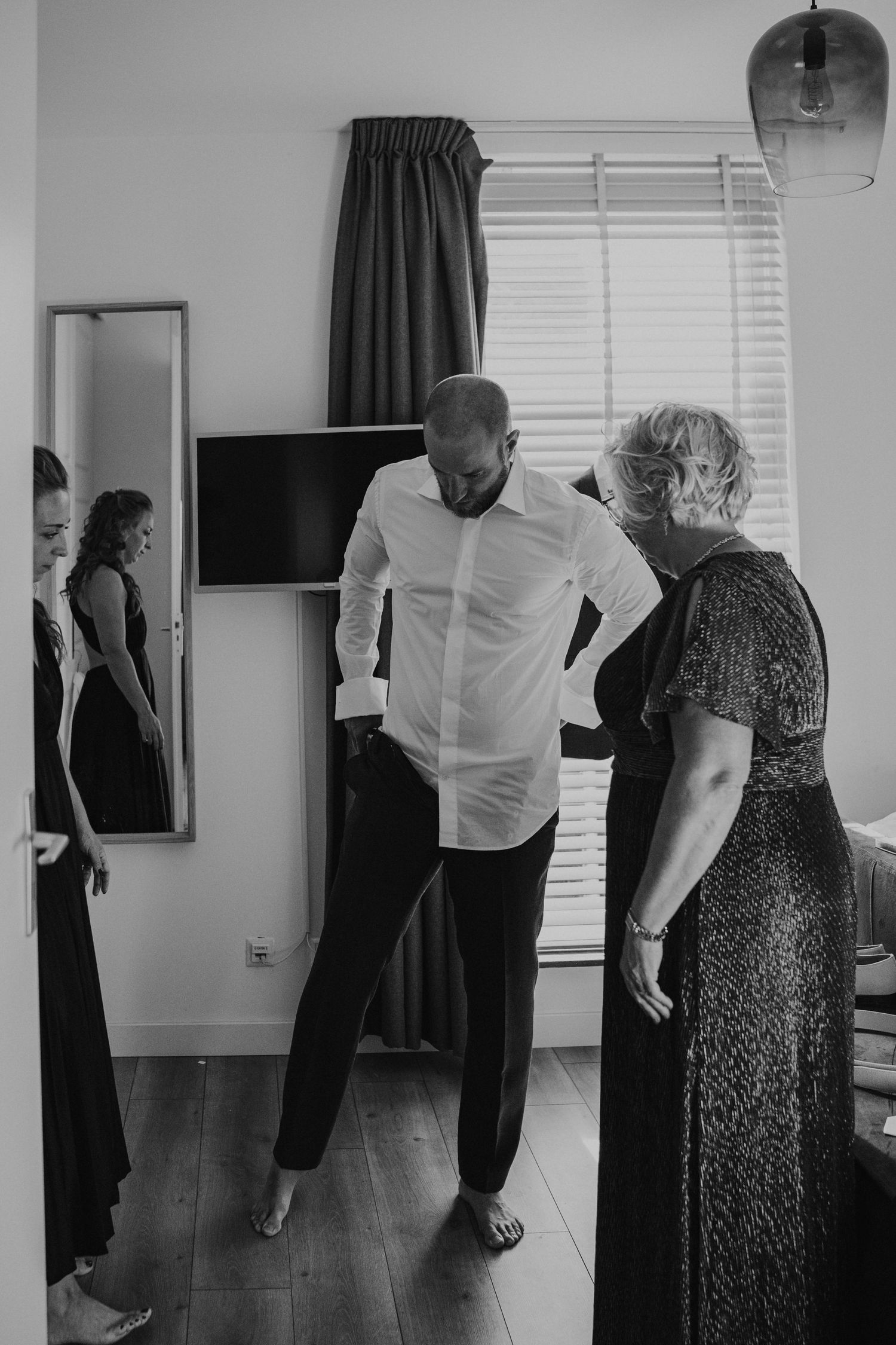 Black and white photo sequence showing a couple dancing together in an indoor space.