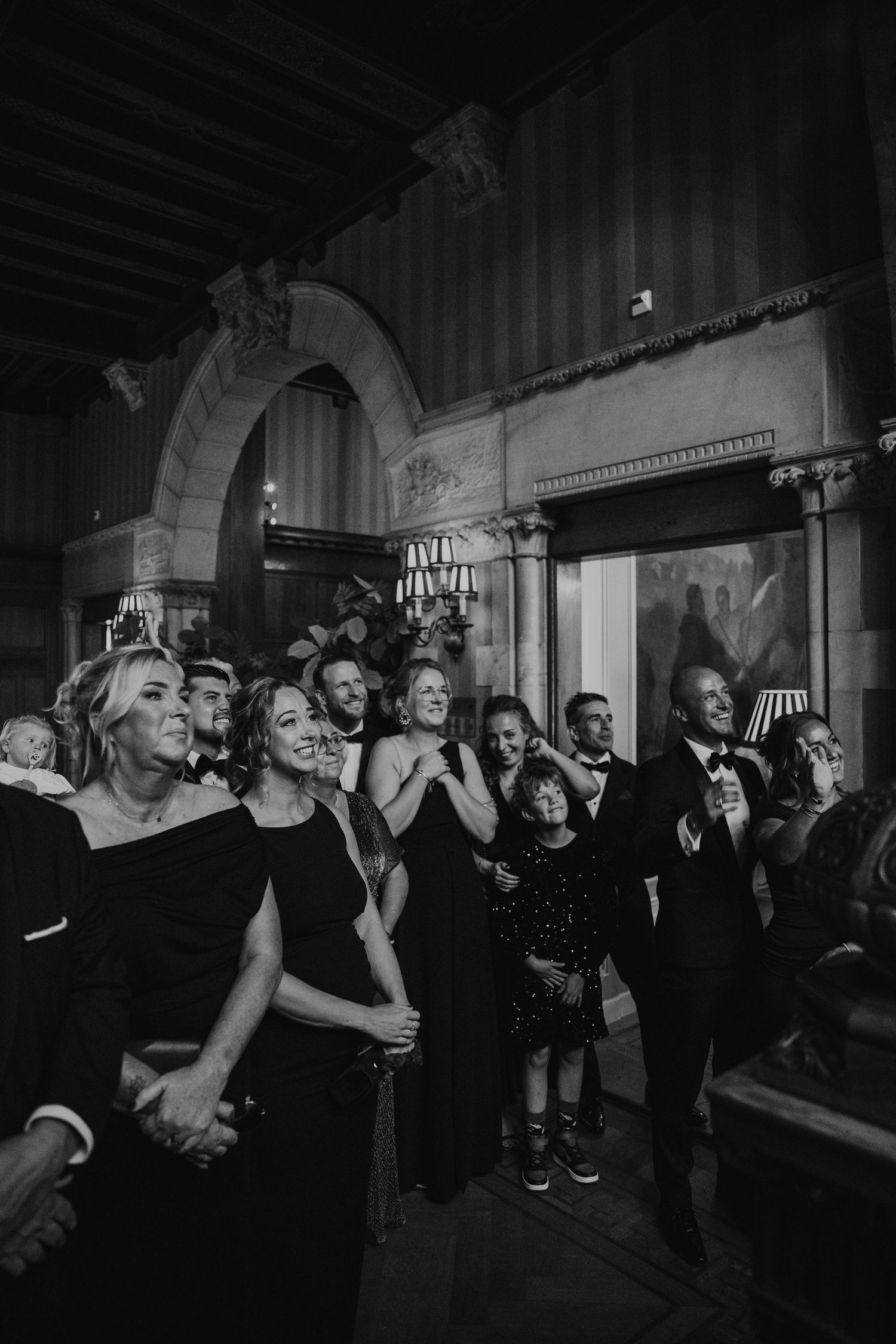 Black and white photos showing guests dancing and celebrating at a lively indoor party reception.
