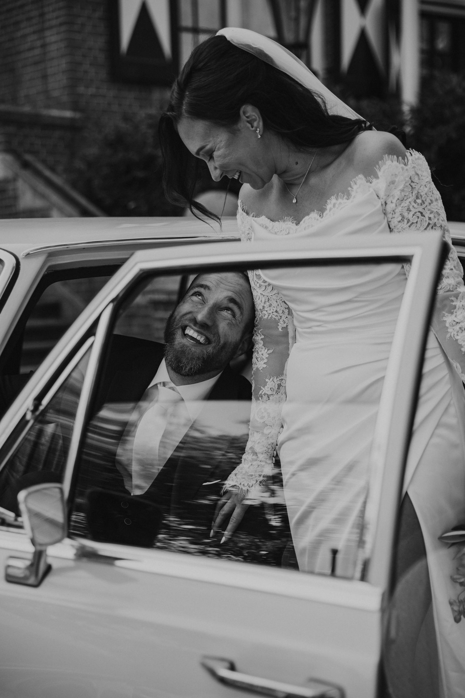 A sequence of black and white photos showing a bride entering a classic car on her wedding day.