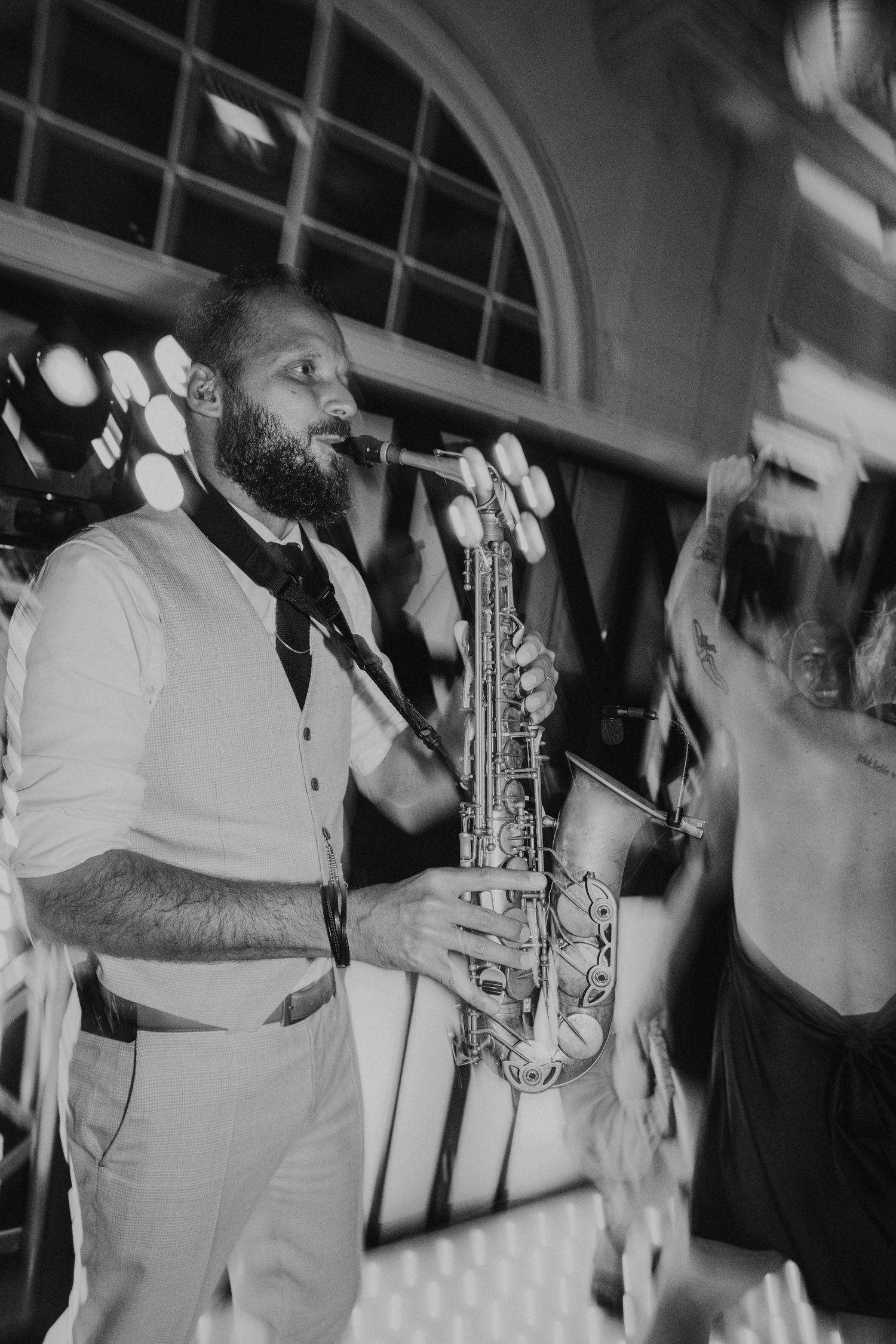 A black and white photo sequence shows a saxophone player performing in a white outfit against a dark background.
