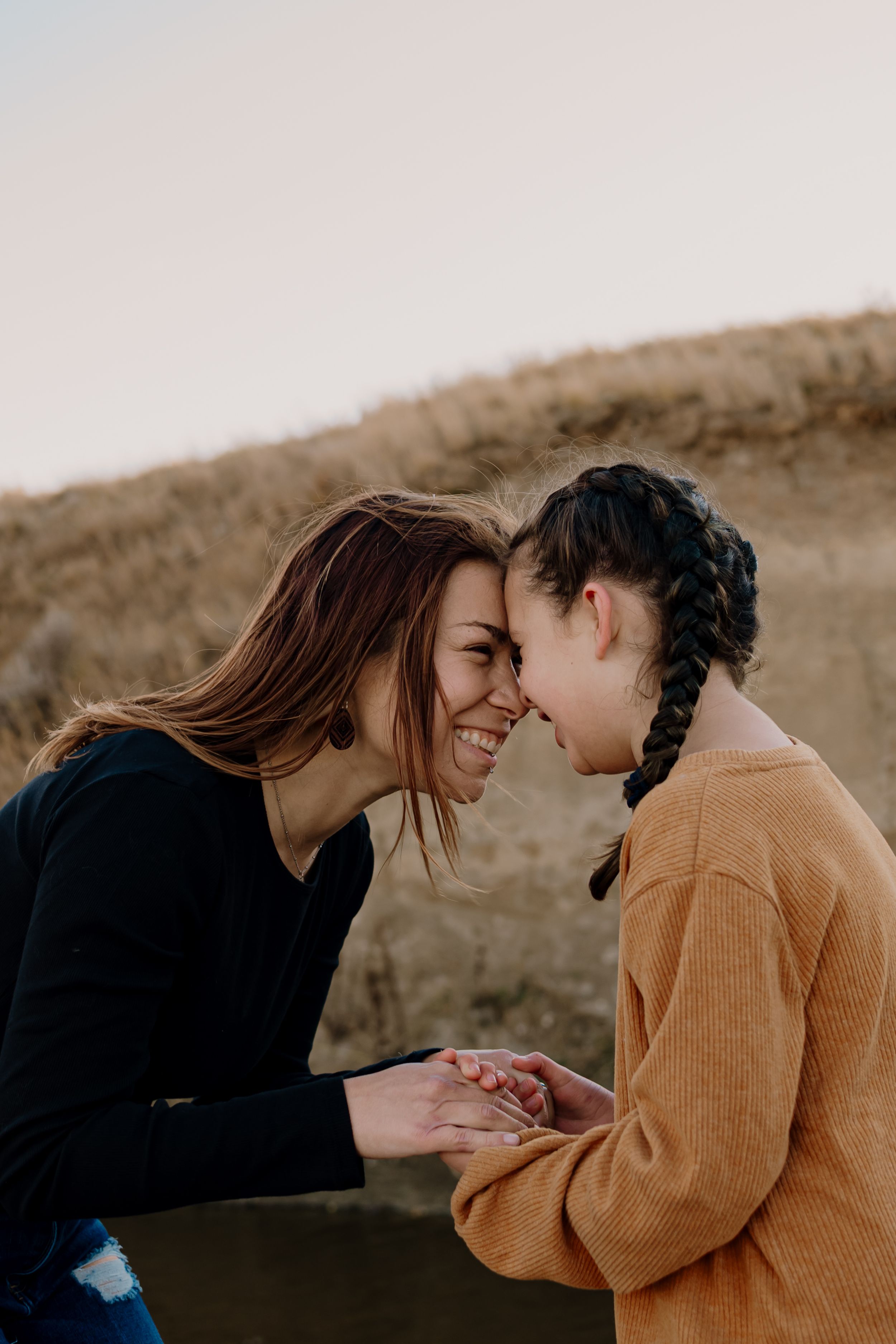 Two people share intimate moments together in a series of warm-toned outdoor photographs.