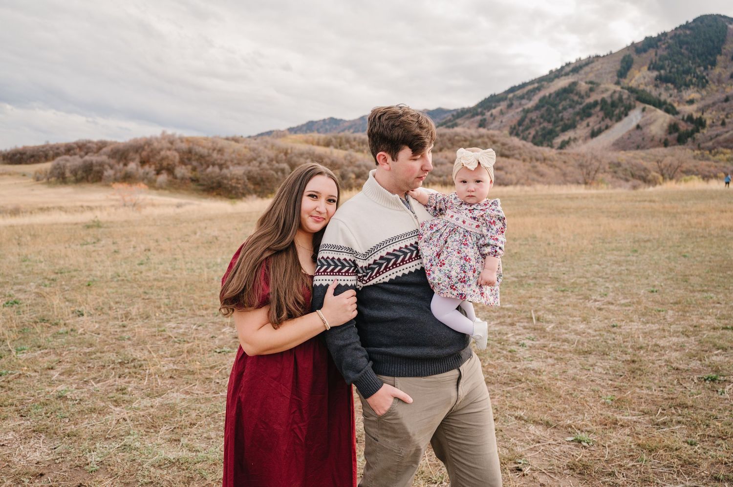 Romantic outdoor photography session in a scenic mountain landscape with warm autumn tones.