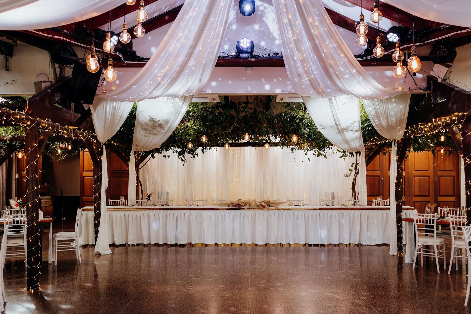 Wedding guests toss colorful confetti in celebration during an outdoor ceremony.