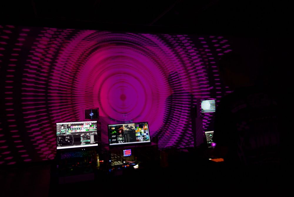 NikitaVisiion, founder of MHYSA Consultancy projecting her immersive visual art on art gallery walls with a crowd watching