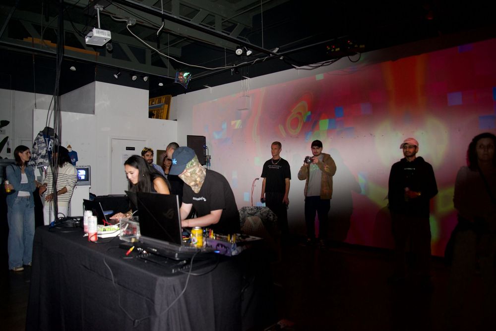 NikitaVisiion, founder of MHYSA Consultancy, and Analog Mannequinn collaborating on live immersive visual art projected on gallery walls