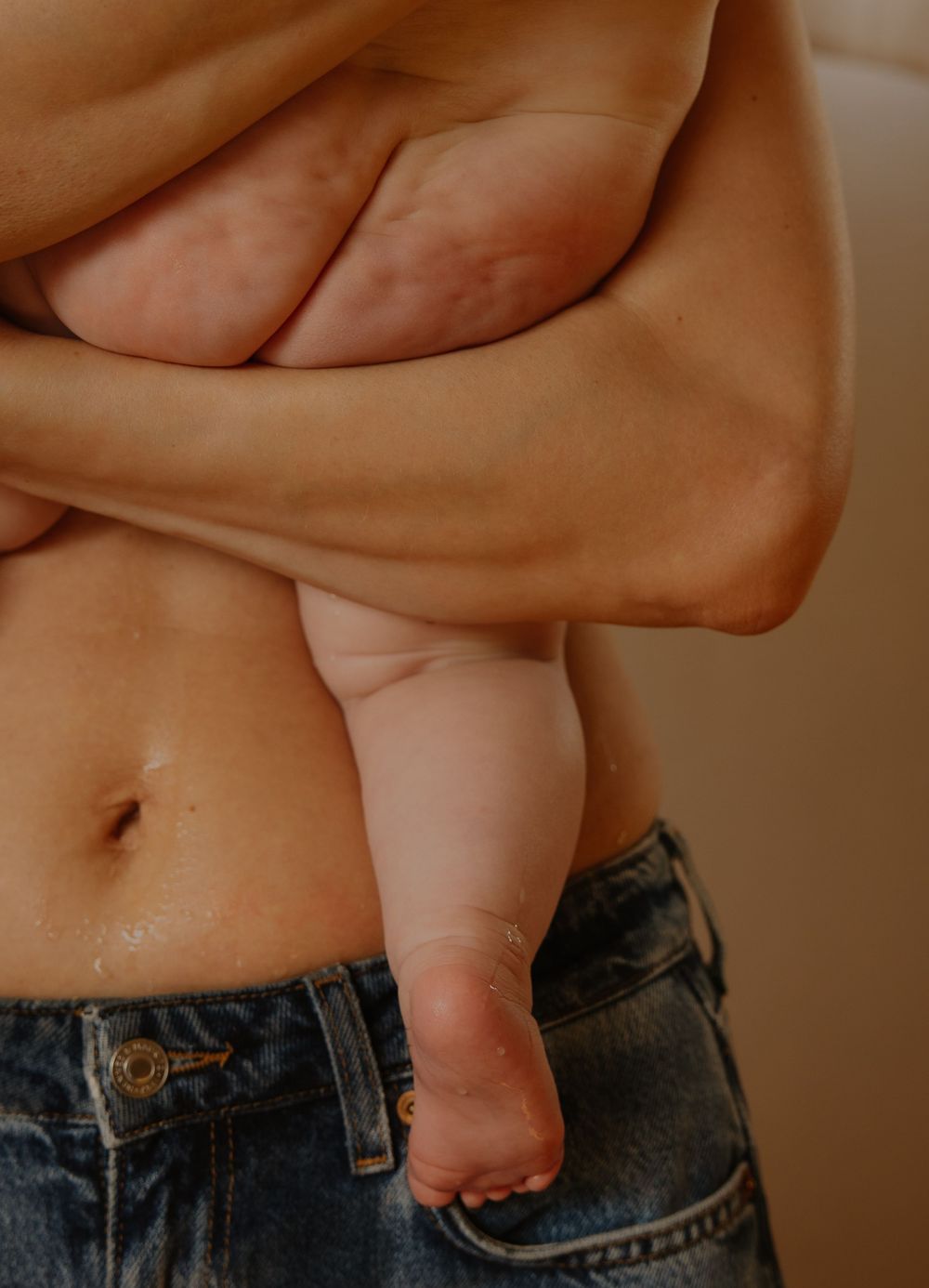 Close-up sequence showing someone pinching and measuring excess belly fat above jeans waistband.