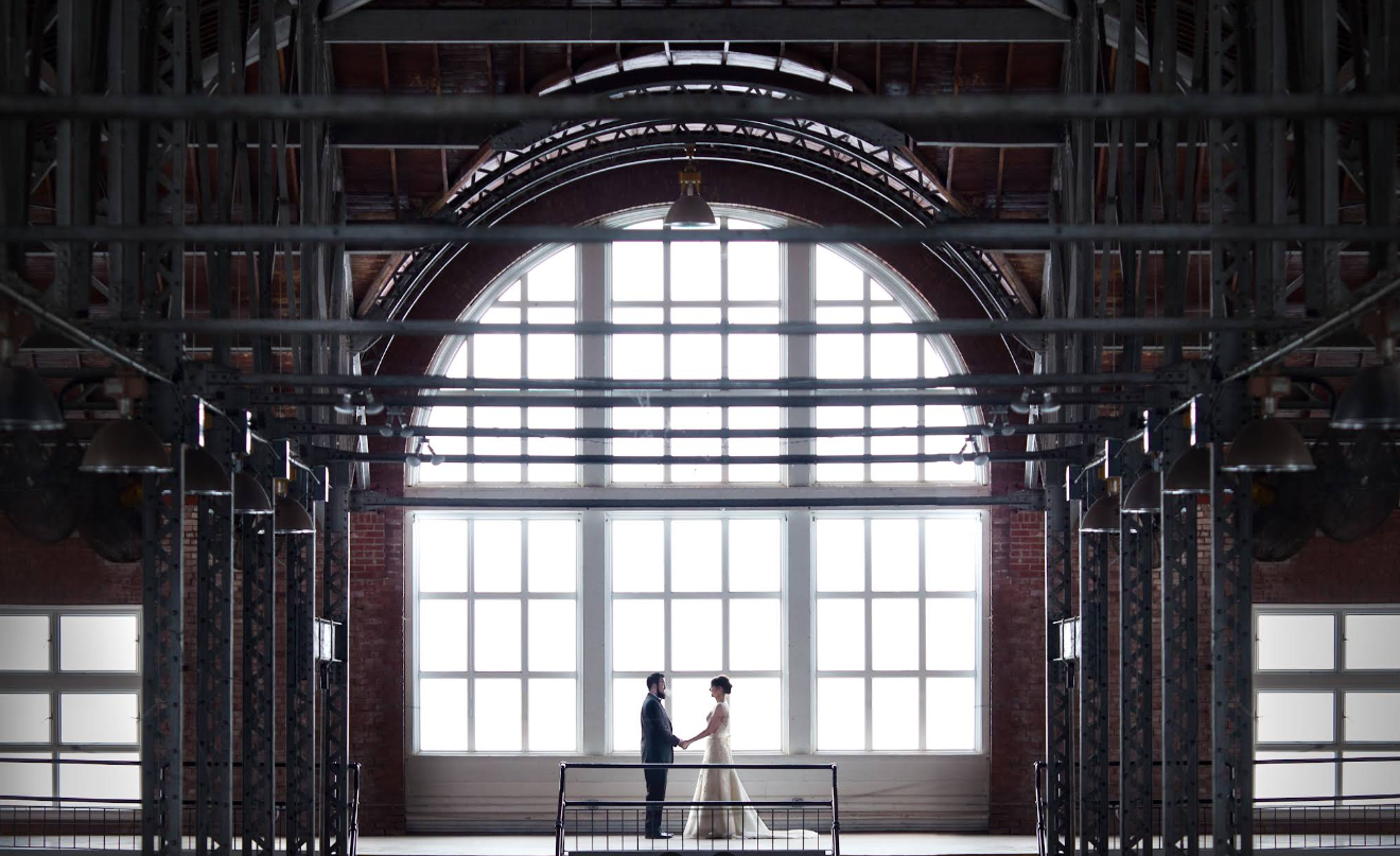 Bride and groom at the Iowa State Fairgrounds in Des Moines, Iowa. Modern, dramatic lighting and architecture.