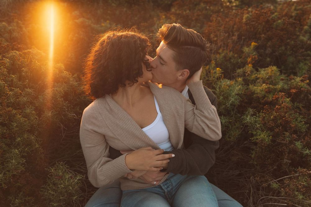 Romantic sunset photoshoot with warm golden light filtering through trees.