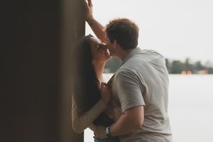 Intimate moment shared between two people on a dock at dusk.