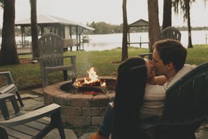 A cozy outdoor seating area with a fire pit glowing at dusk.