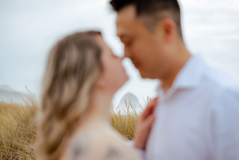 Intimate close-up of couple sharing tender moment outdoors.