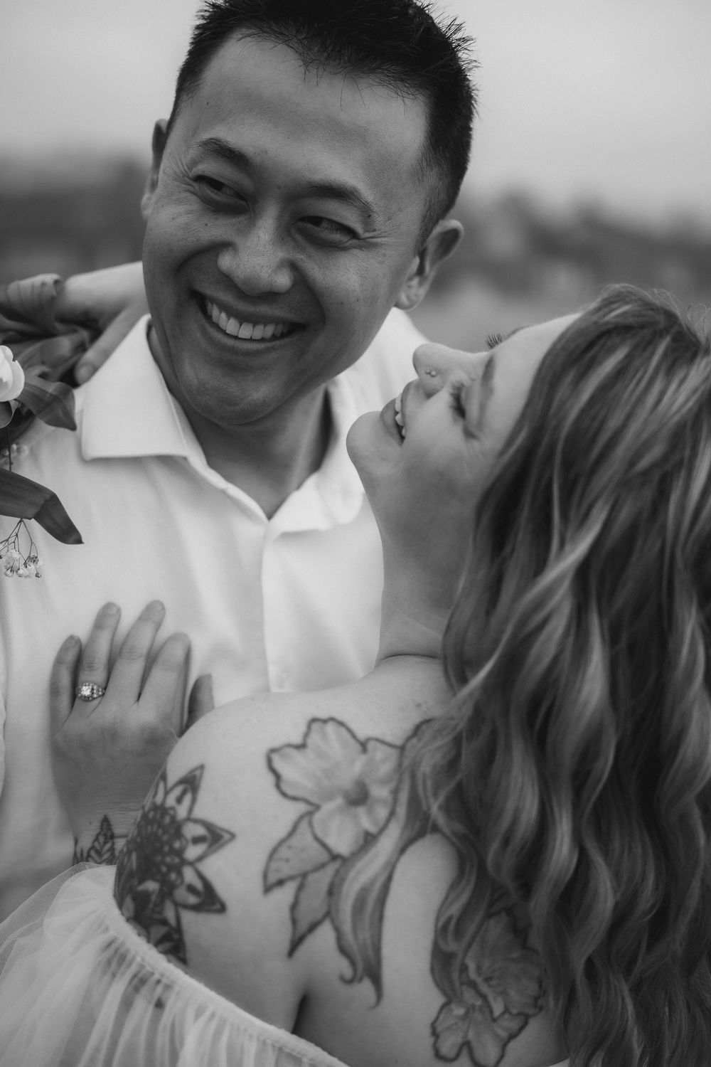 Black and white portrait series showing intimate moments between a couple with visible tattoos.