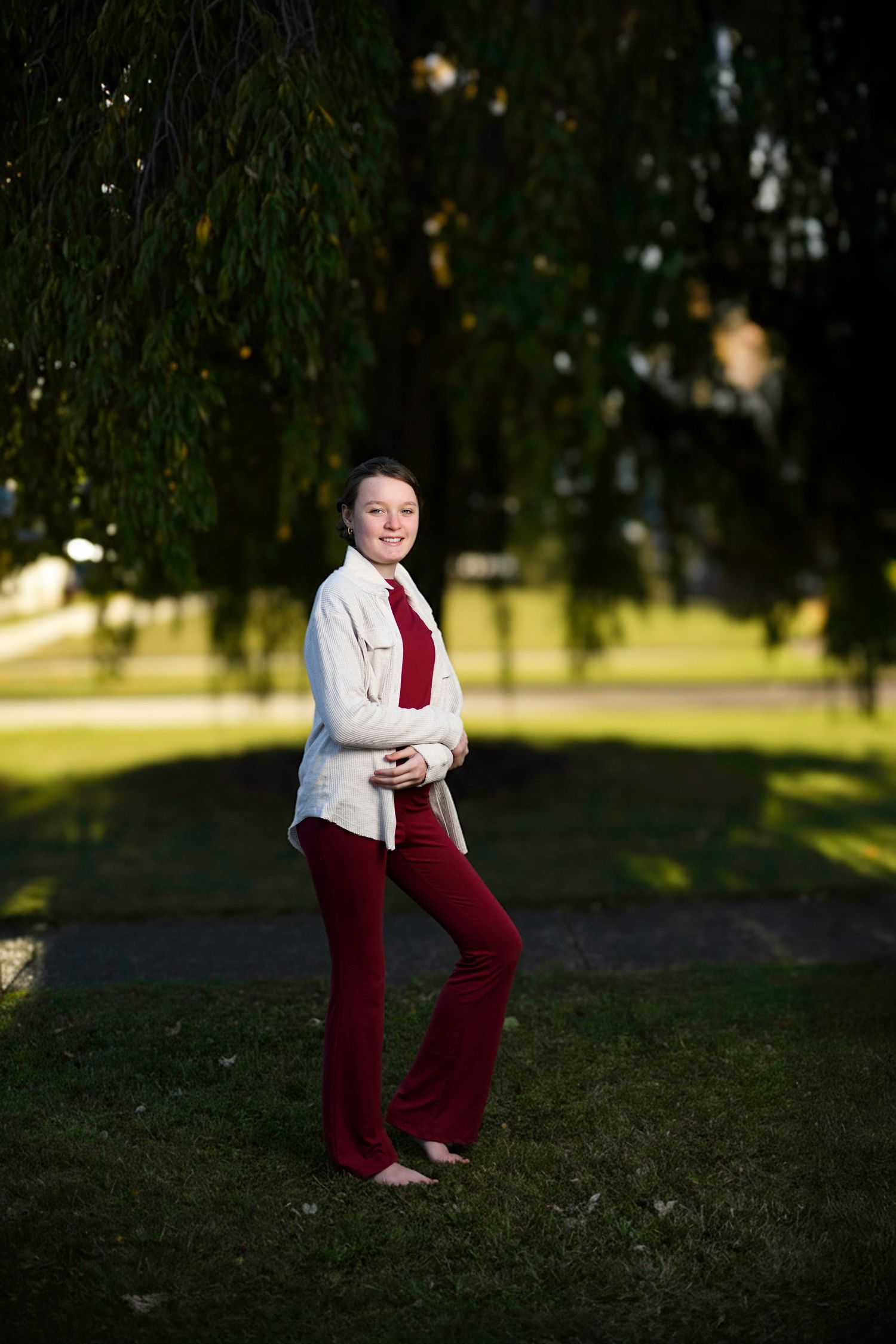 Full body portrait with crisp flash lighting and soft golden background captured using high-speed sync technique.