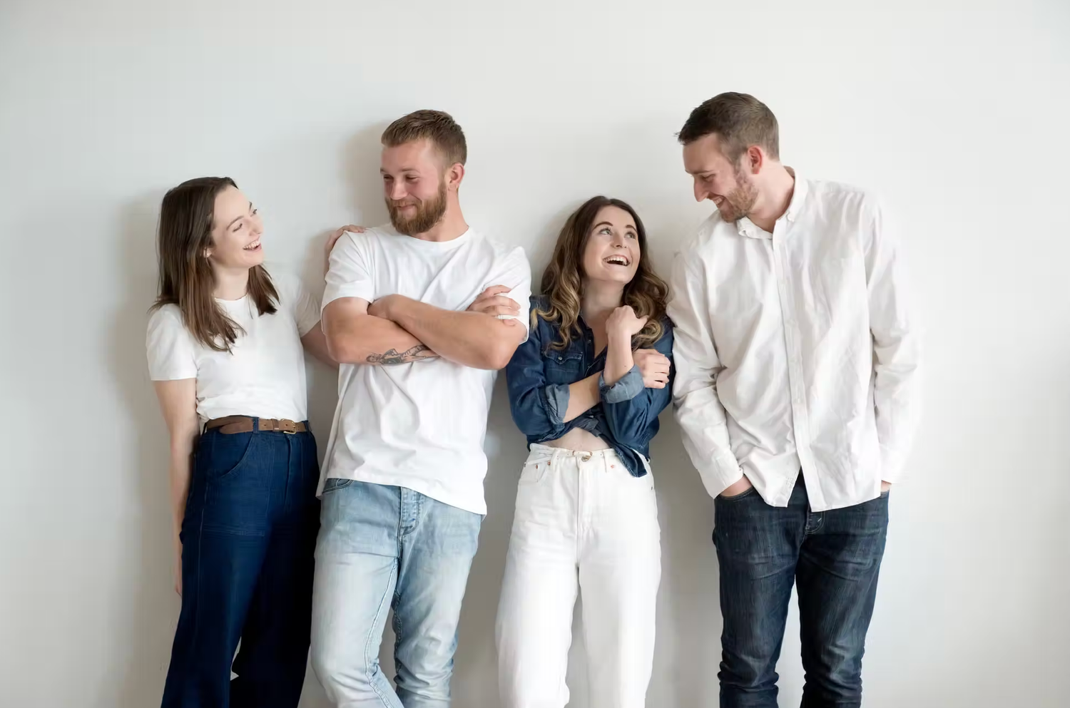 Casual family photoshoot with members wearing coordinated blue and white outfits.
