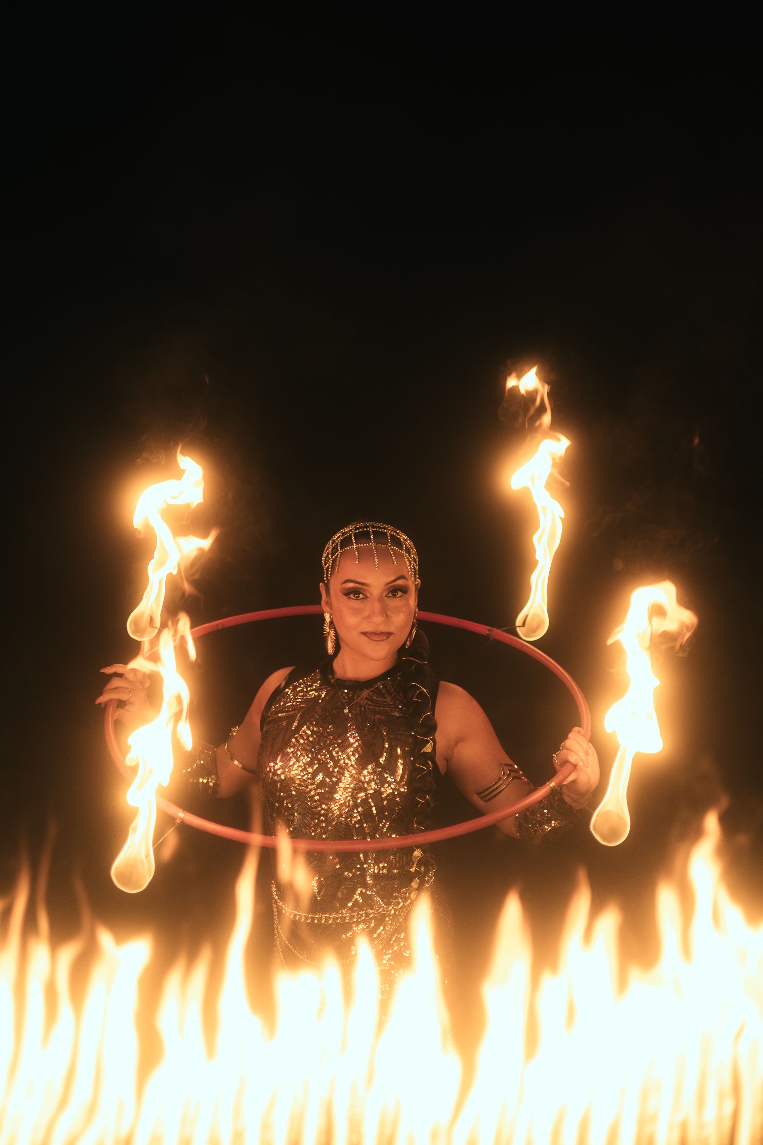 Fort Lauderdale fire performance photographed by Mannyportraits. Multiple flame props with symmetrical stage presentation and bold expressio