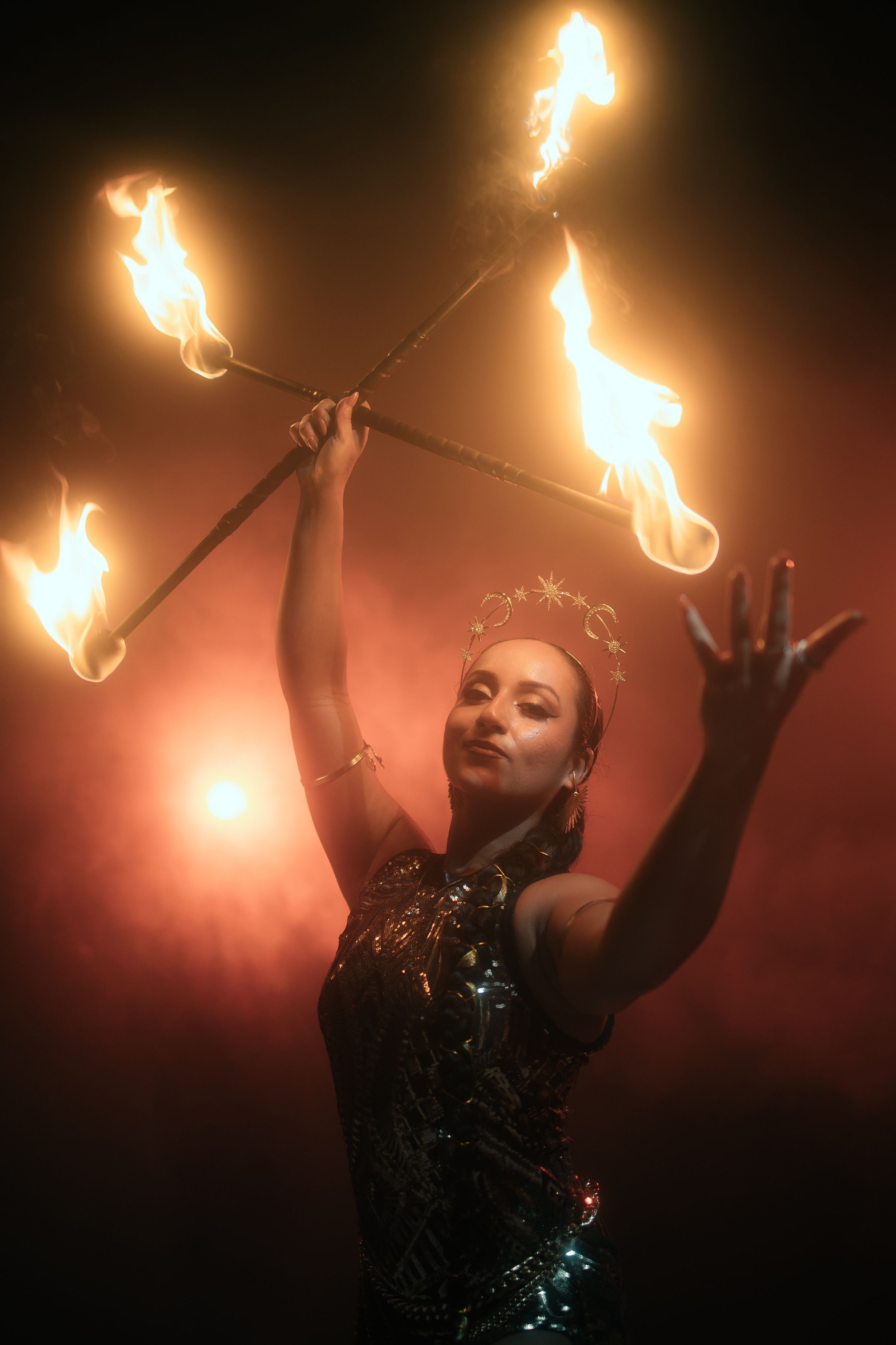 Fire dance performance shot by Mannyportraits in Miami. Vertical flame movement with dramatic stage shadows and emotional intensity.