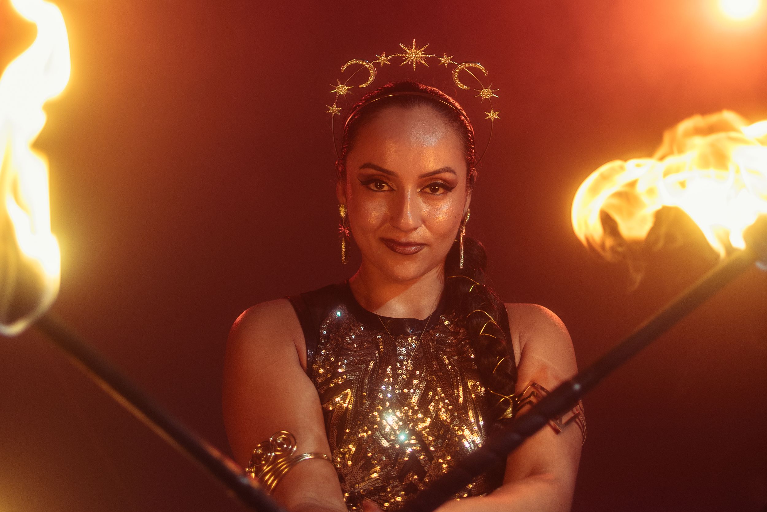 West Palm Beach fire performer captured by Mannyportraits. Confident smile, flame props, and warm theatrical lighting.