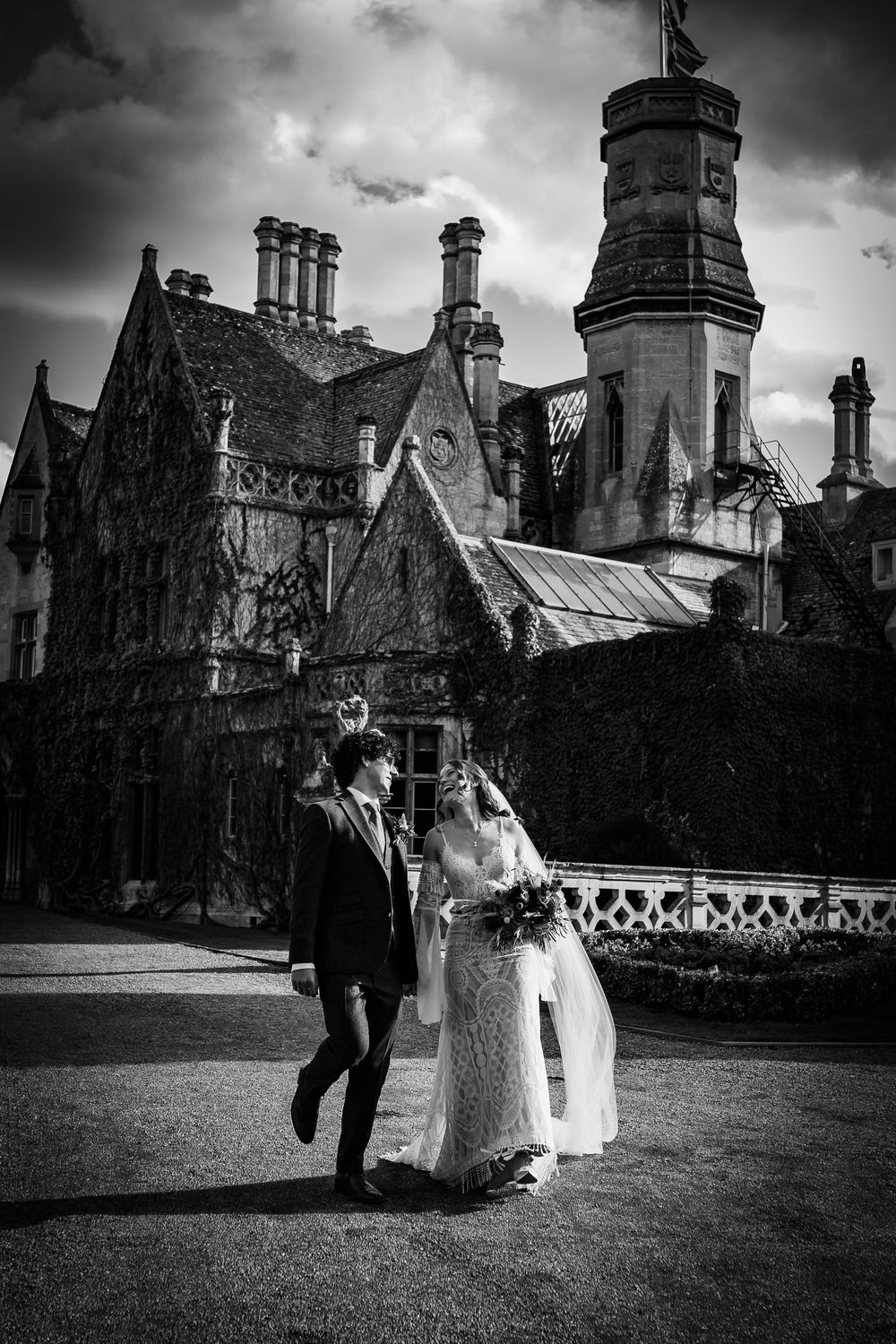 A romantic black and white wedding photo sequence showing a couple dancing and celebrating at a historic castle venue.