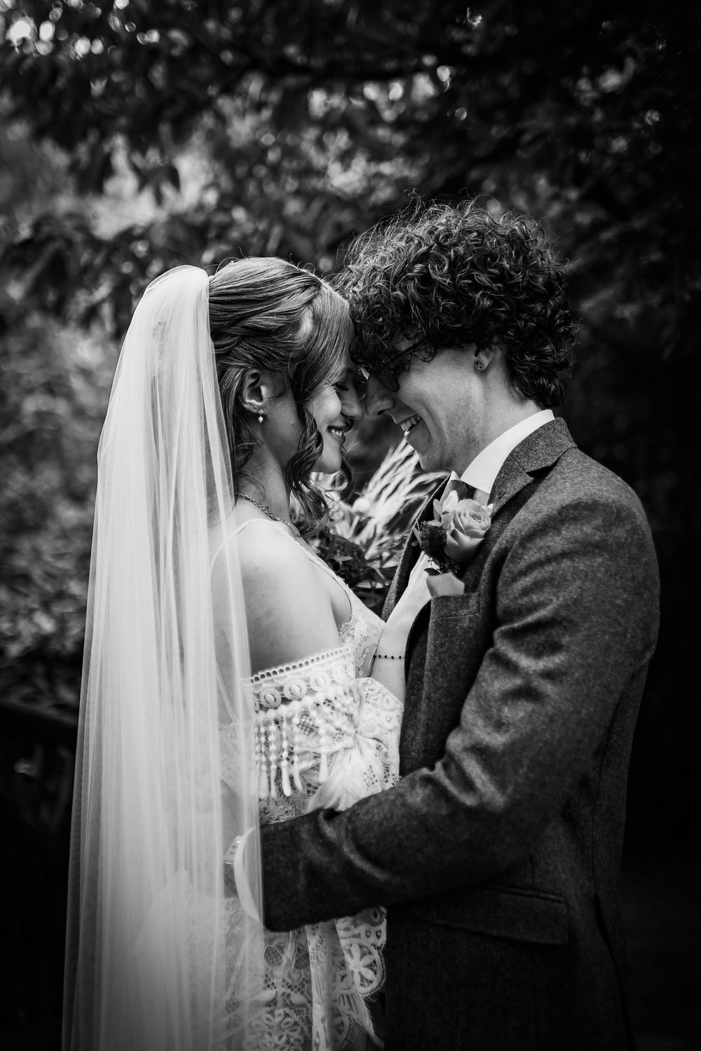 Black and white wedding portraits showing tender emotional moments between newlyweds.
