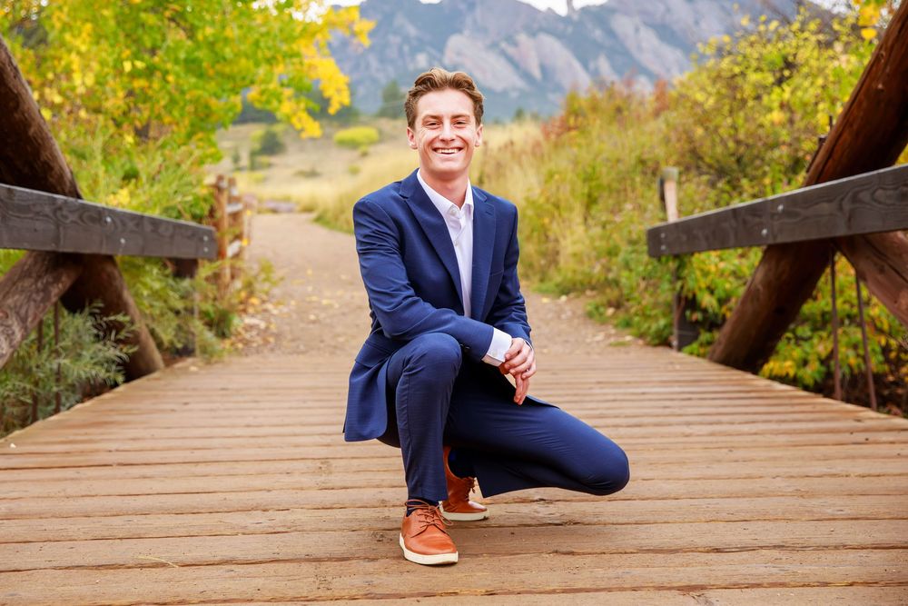 Professional photography composite showing five poses on a wooden boardwalk with mountain scenery in the background.