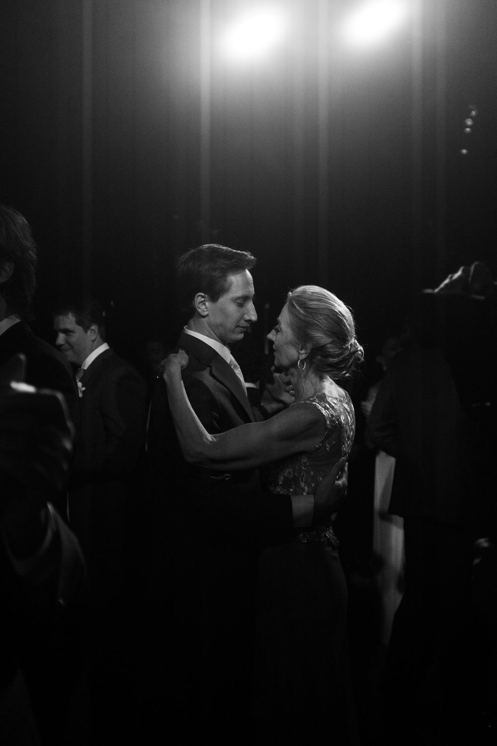 Black and white photo of couples slow dancing at an elegant evening event.