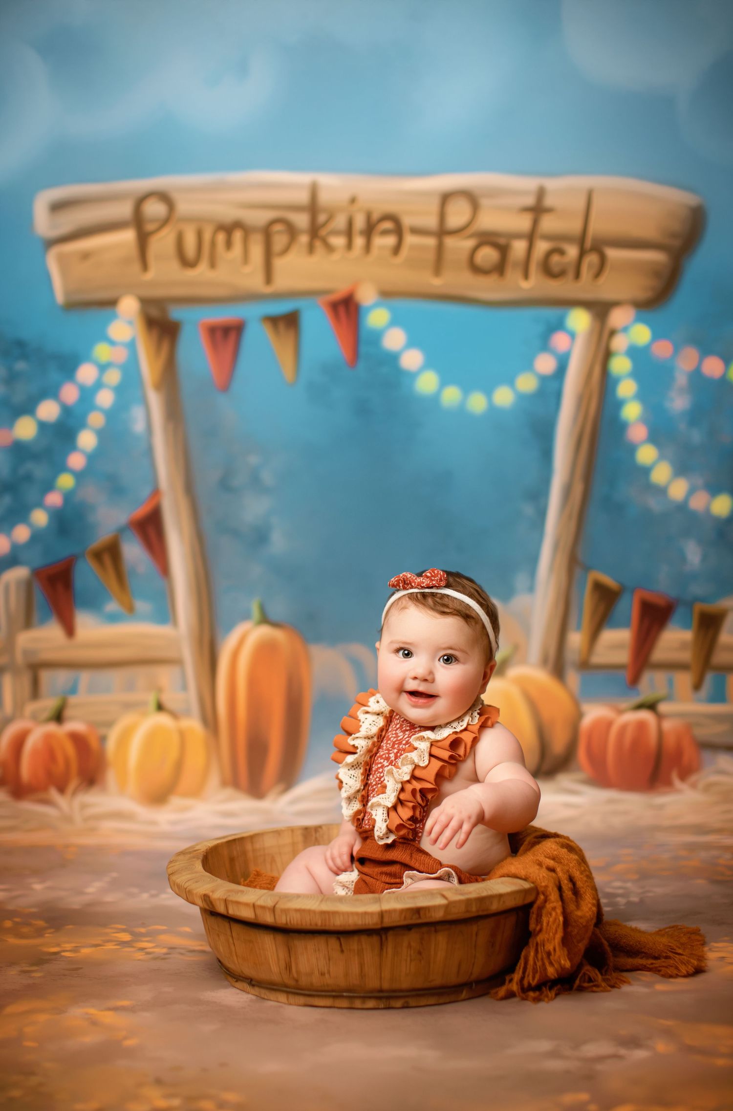 Fall themed photo set features rustic wooden signs, string lights, and a wooden barrel prop against a blue backdrop.