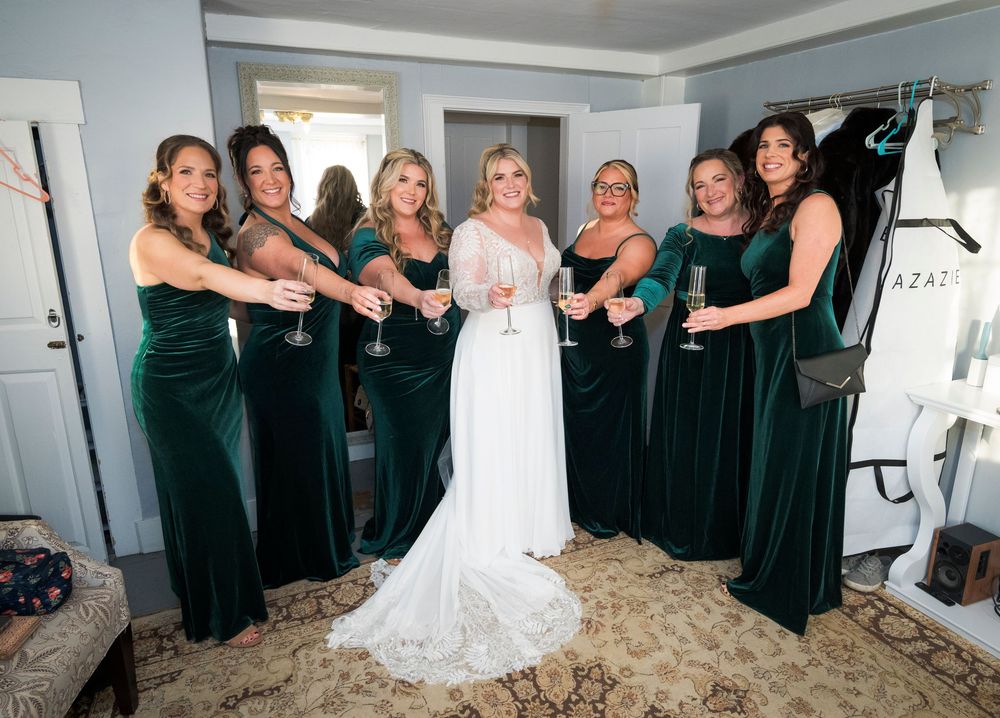 A wedding party wearing black dresses and a white gown pose together in a series of candid celebration photos.