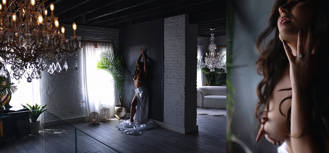 Crystal chandeliers hang elegantly in a dimly lit corridor creating a luxurious atmosphere.