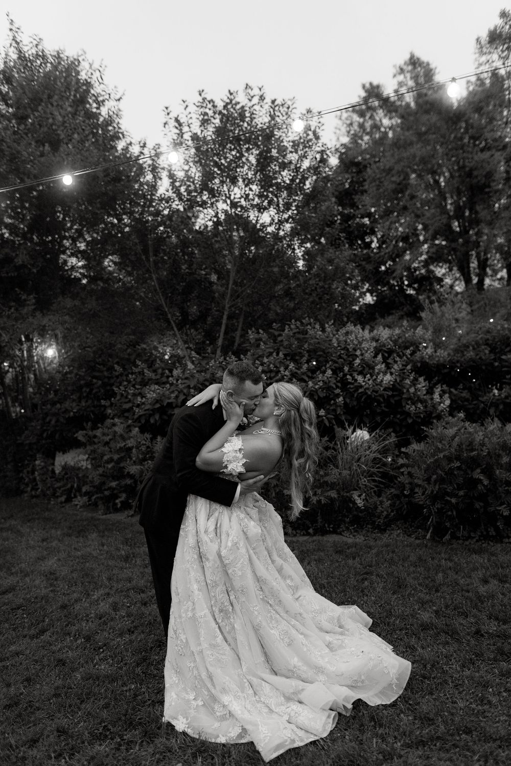 Black and white photo sequence of a couple dancing together in an outdoor garden setting at dusk.