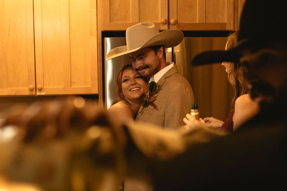 micro wedding reception - couple cuddles into each other