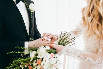 Elegant wedding details featuring floral arrangements, bouquets and table settings in soft whites and greens.