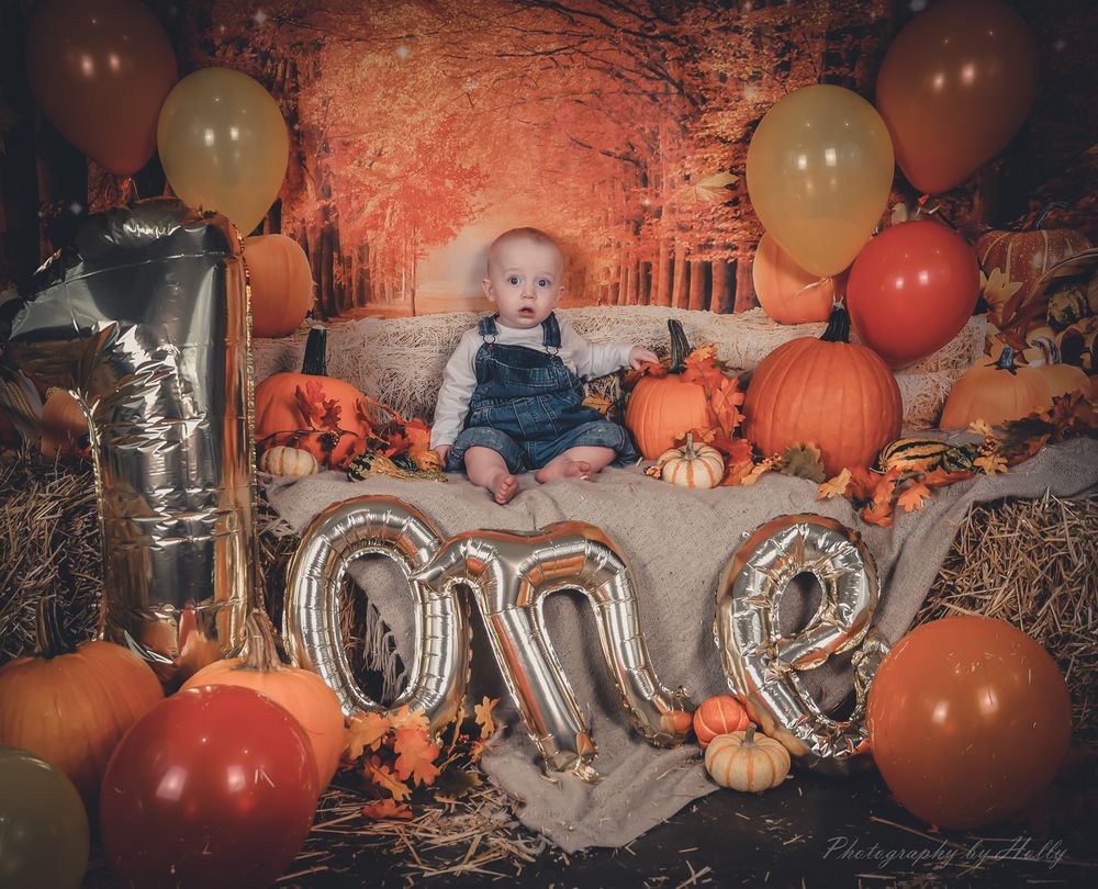 Silver balloon letters and autumn decor with pumpkins and balloons create a festive fall celebration display.