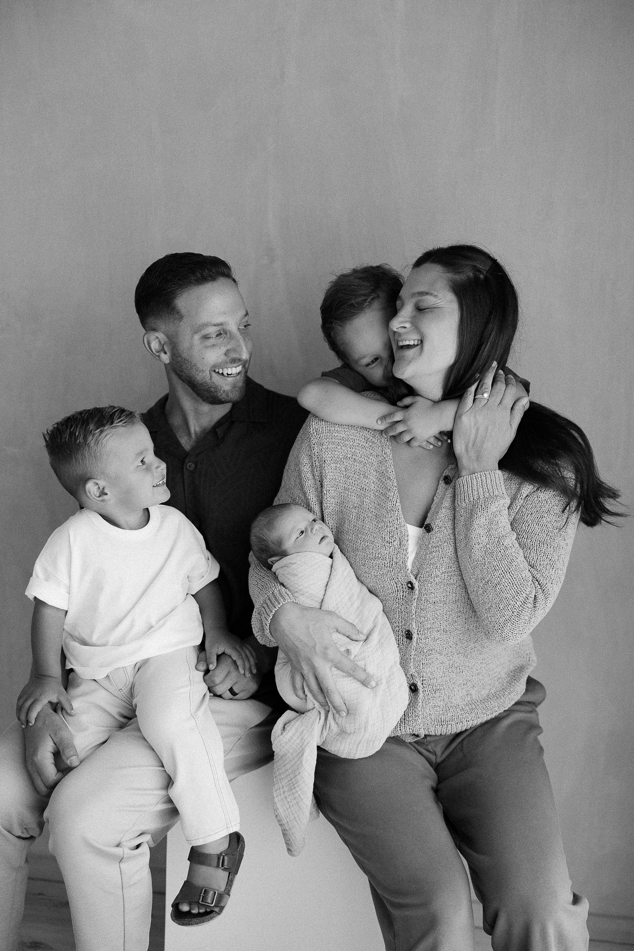 Family of 5 picture poses with newborn in California minimalist studio